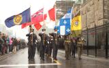 2012 Memorial Service - Officers with flags marching in front of onlookers