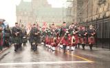 2012 Memorial Service - Officers with bagpipes marching in front of onlookers (6)