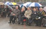 2012 Memorial Service - guests at memorial service in the rain with umbrellas (7)
